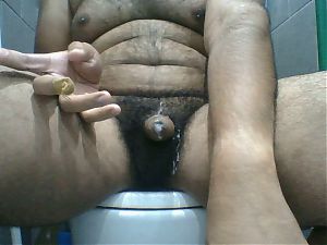 Indian guy enjoying himself with an oil shower