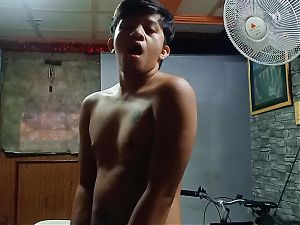 SPORTY ASIA TEEN WANKS IN FRONT OF HIS BIKE